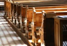 Dem Stopped Going to Church Because Republicans Were There wooden church pews in sunlight