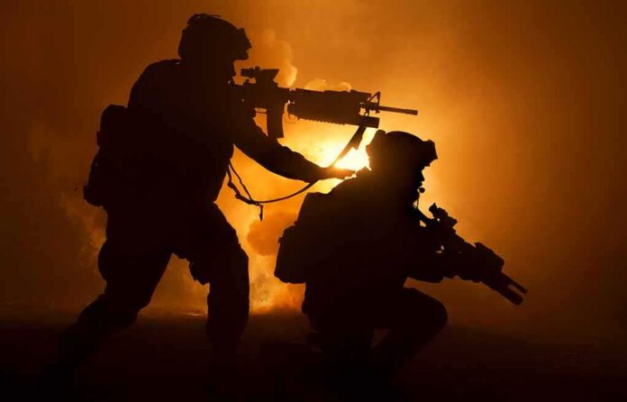 Two armed soldiers silhouetted against fiery smoke