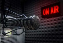 Radio Stations REMOVE Artist Over Gaza Controversy Close-up of a studio microphone with an illuminated on-air sign