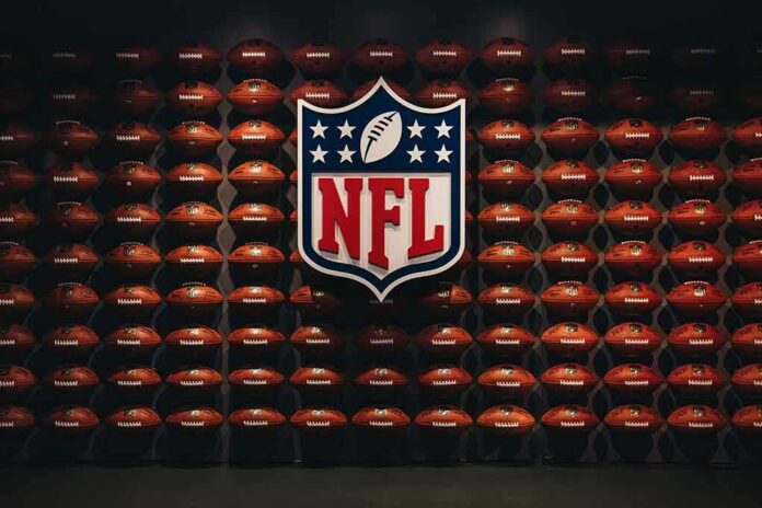 shutterstock_1284860743 NFL shield logo over wall of footballs