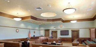 Female ARRESTED Outside Clancy Courthouse After She Did THIS Empty courtroom with wooden benches and judge's bench