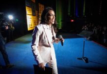 AOC Gets Destroyed in Fact Check on ‘Black Lynchings’ — This Is Humiliating Woman in a light suit holding a microphone on a stage