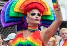 James Talarico’s OBSESSION With Drag Queens Gets Weirder Drag performer in vibrant rainbow costume at a parade