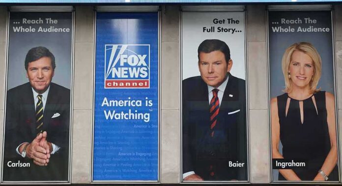 Tucker Carlson and Bret Baier on large Fox News promotional posters