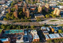 Gang Crossfire Kills Child — Gunman Vanishes Aerial view of city high-rise apartments and highway