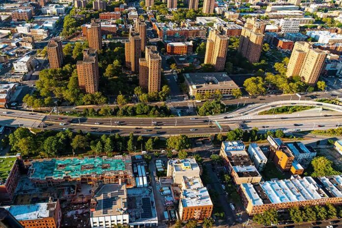 shutterstock_1660324648 Aerial view of city high-rise apartments and highway
