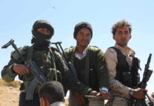 Houthis Claim Attack On Saudi Capital Three armed men standing outdoors