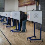 Trump Releases Cybersecurity Plan on Safeguarding the Midterms Voters at polling booths in a gymnasium