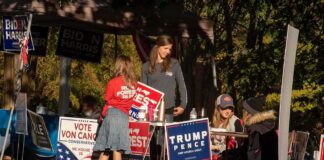 GOP House Nominee Charged in Alleged Cocaine Plot People at a campaign booth with political signs outdoors