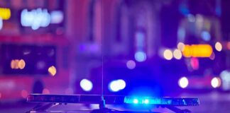 police car roof with flashing blue lights at night