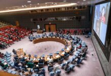 Dem Wants Iran Nukes – Ignites Media Firestorm Delegates seated around a circular conference table in a large chamber