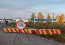 Residents On Polands Border BRACE For Russian Attack Ukraine border crossing with stop sign and barrier