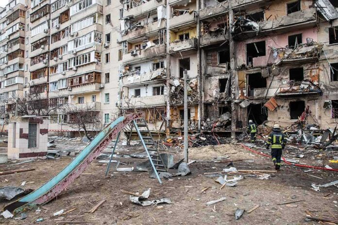 Damaged apartment building behind a playground slide