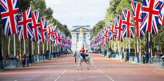mounted guard on white horse along flag-lined boulevard