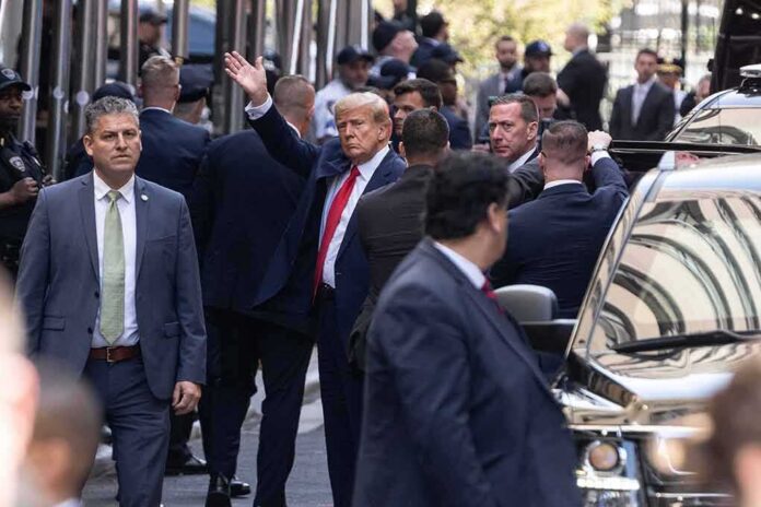 Donald Trump waves amid security detail; Jaz-O and Brandon Doughty present in the crowd