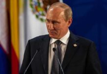 Vladimir Putin at a podium during a formal event