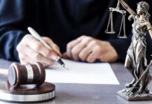 Trump FIRES A.G – Ignites Constitutional Brawl! Judge writing at desk with gavel and Lady Justice statue