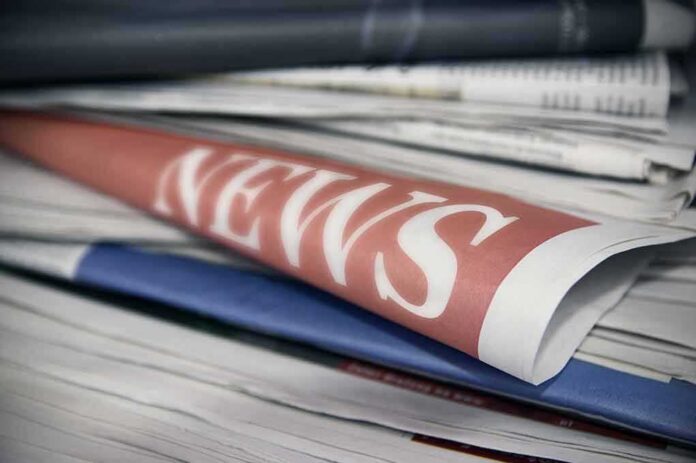 Newspapers stacked with a front page labeled NEWS