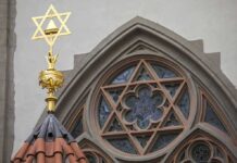 Teen STABBED In Synagogue Attack Star of David atop synagogue roof with stained glass window