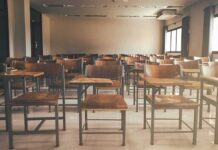 University Blocks Congressman – Stay Out! Empty classroom with rows of wooden desks and chairs