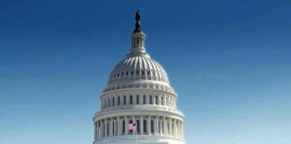 United States Capitol building with dome under clear blue sky