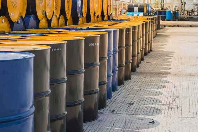 Rows of industrial metal barrels with yellow lids
