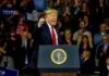 Donald Trump speaking at a rally behind a presidential podium