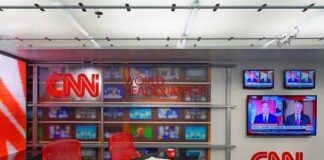 Veteran CNN Icon Quits After 43 Years CNN newsroom set with red chairs and multiple TVs