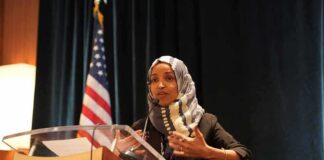 Omar’s Sisters Damning Text Message OUTED Her Ilhan Omar speaking at a podium with a microphone