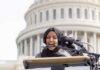 Shaken Ilhan Omar BEGS For Cash Woman in hijab speaking at podium with microphones