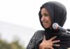 FBI Raid Hits Omar’s Home Ilhan Omar speaking at a microphone with hand on chest