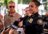 Police chief speaking to reporters with microphones
