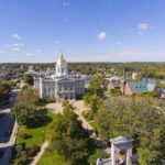 State capitol building with golden dome in a small city