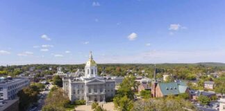 State capitol building with golden dome in a small city