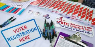 Talarico Explains his 2-Week Campaign Absence Voter registration table with forms, pens, and informational materials
