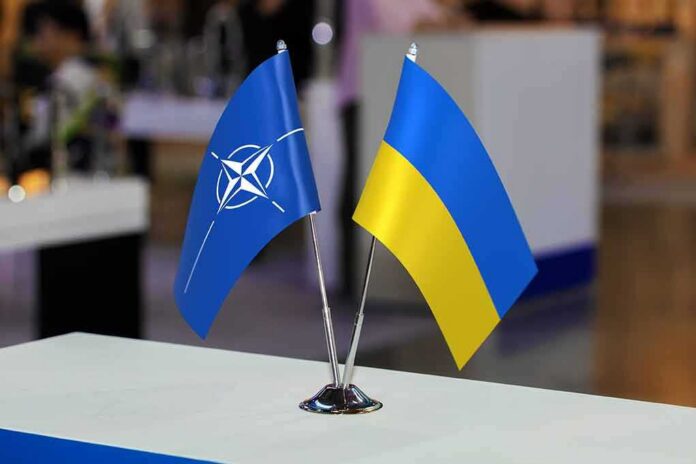 shutterstock_2316436439 NATO and Ukraine table flags on a small metal stand