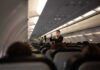 Flight attendant demonstrates safety procedures in airplane cabin